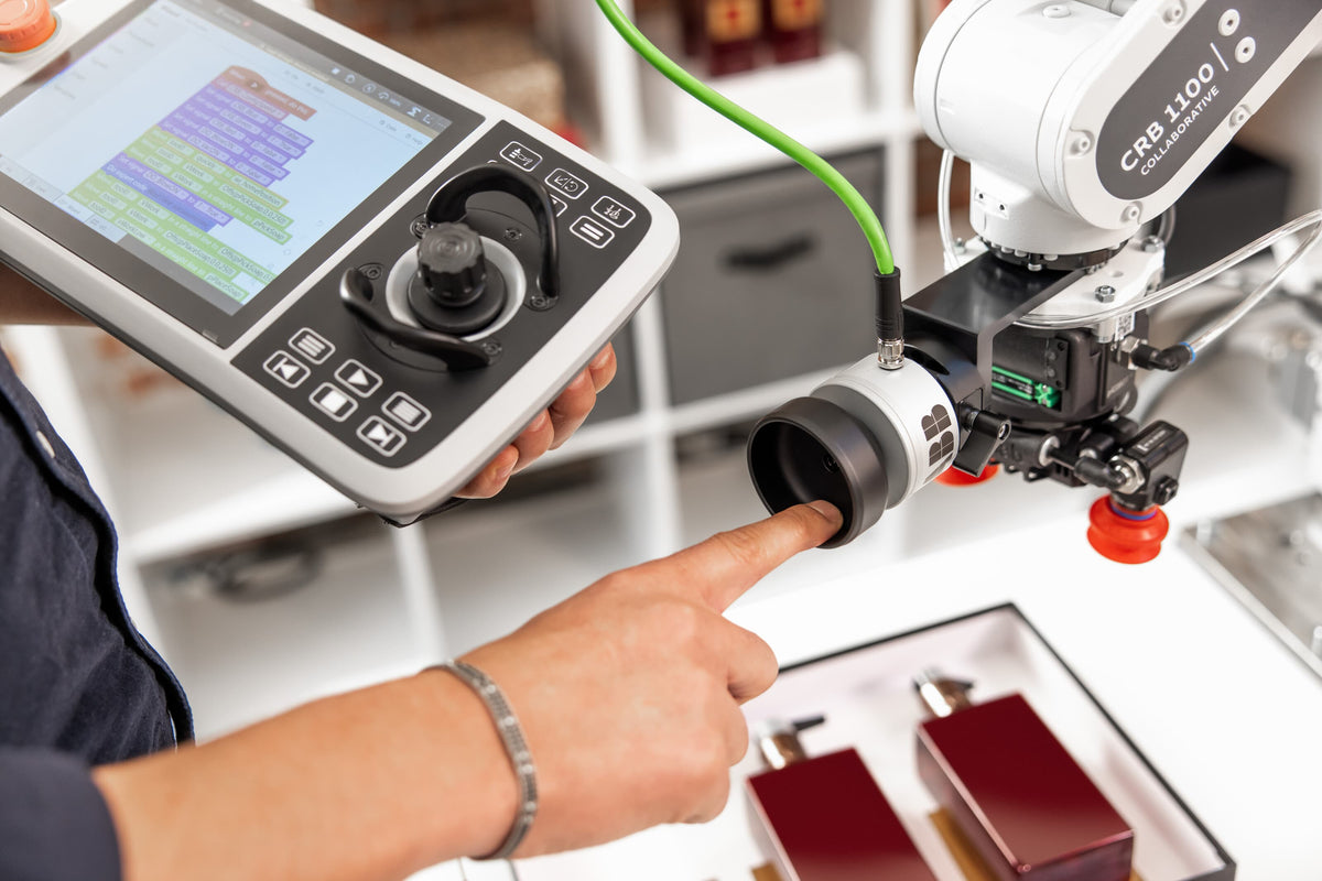 Industrial robot and operator interface in an automated manufacturing workcell